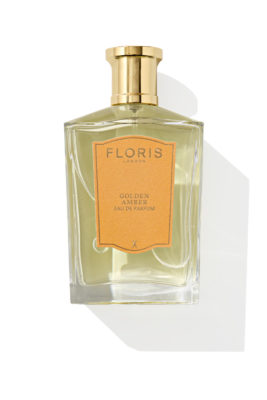 Gold perfume bottle on white background
