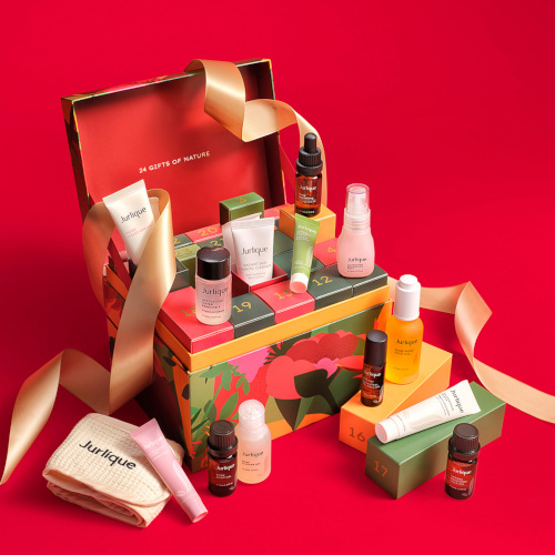 Colourful box filled with skincare on red background