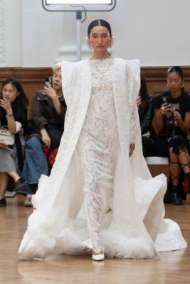 Model on runway in white outfit from MITHRIDATE SS25 collection