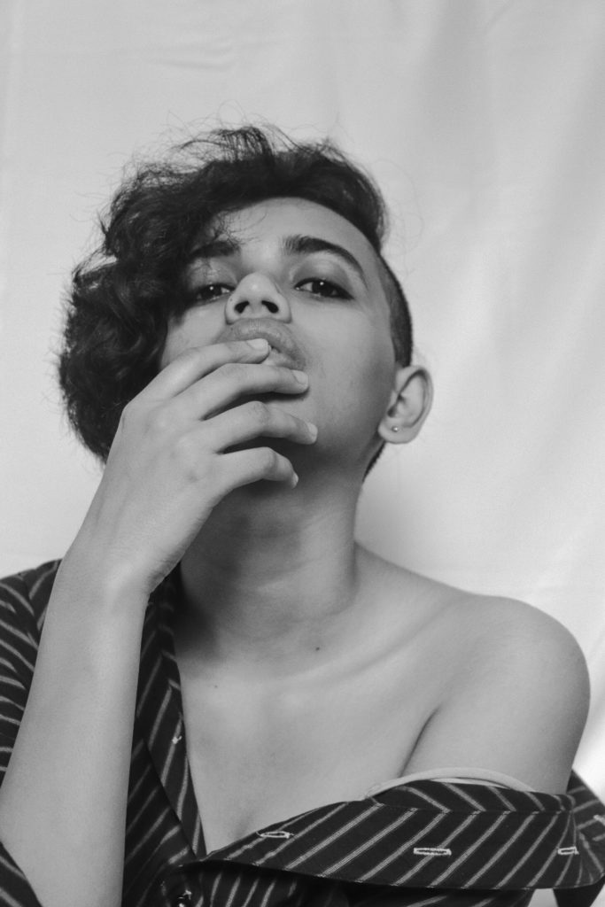 Black and white photo of woman with undercut pixie bob