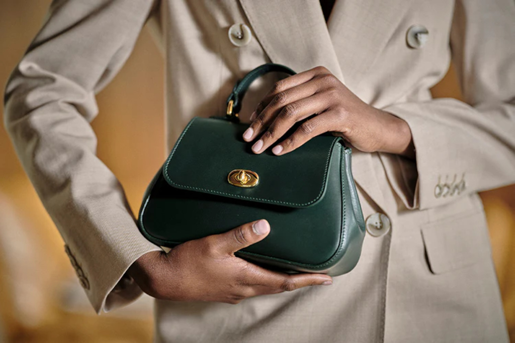 Close up of hands holding green bag