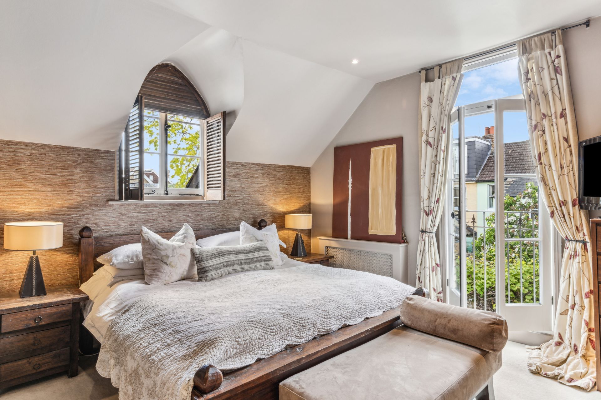Bedroom with arched window and chaise longue
