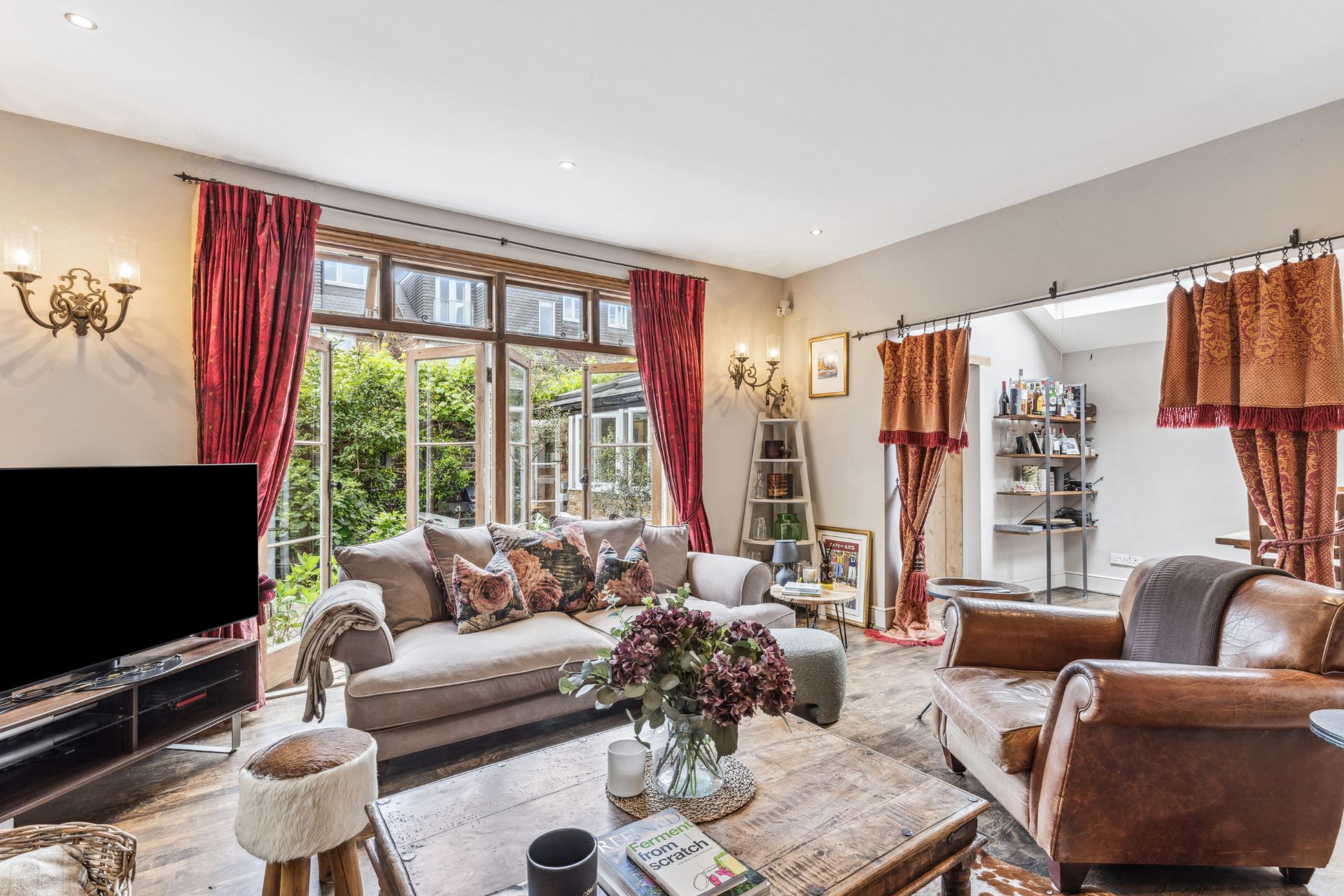 Living room with grey sofas and red curtains