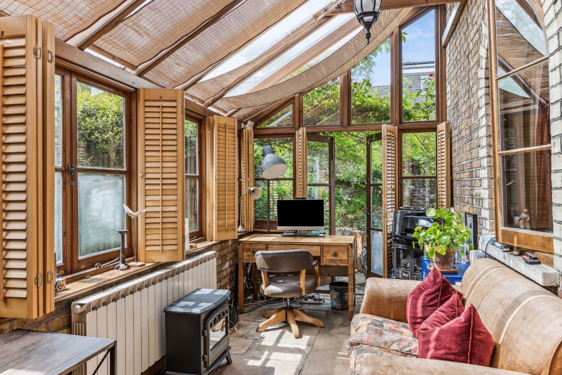 Conservatory office space with cream sofa