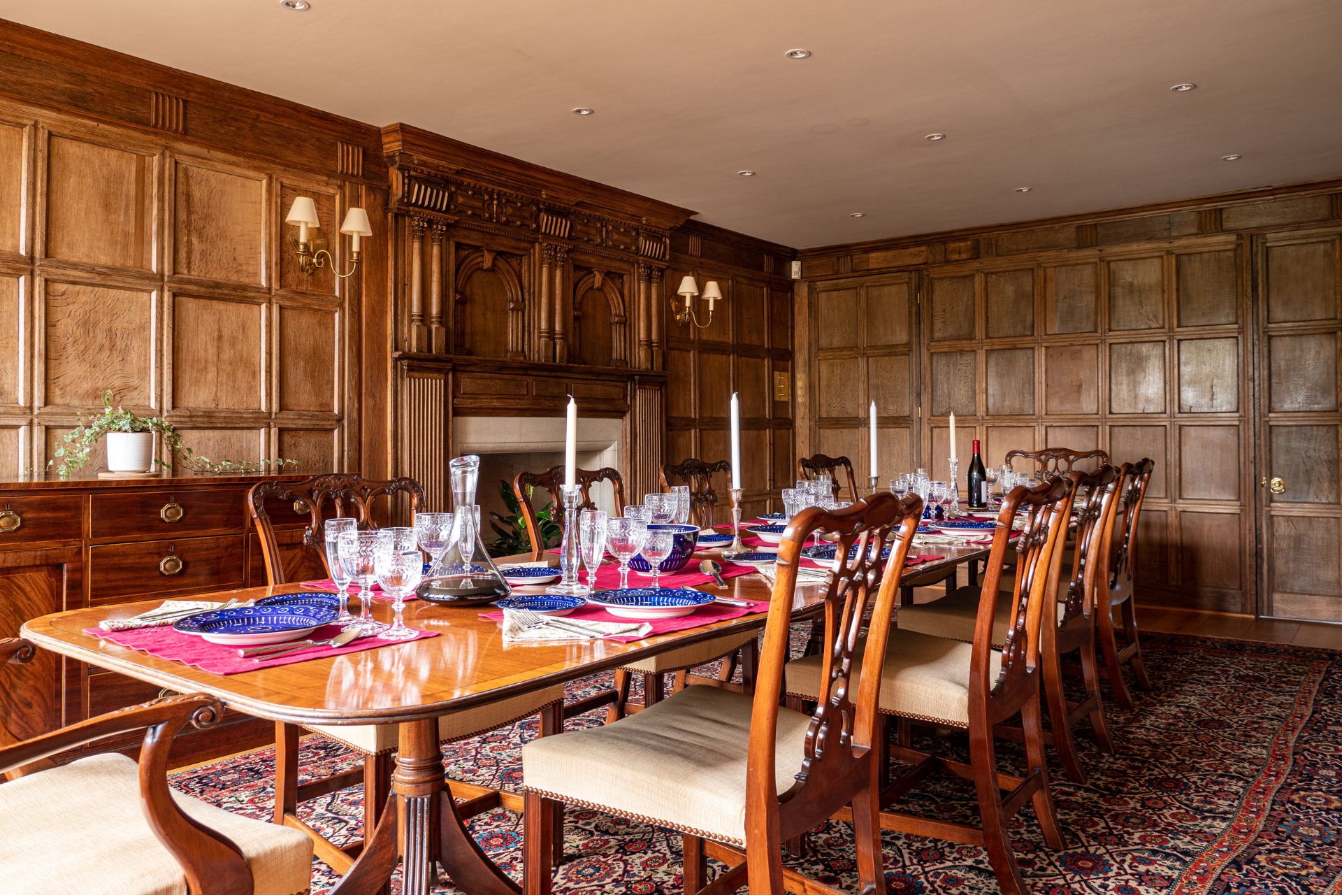 Oak-panelled dining room with long wooden table.