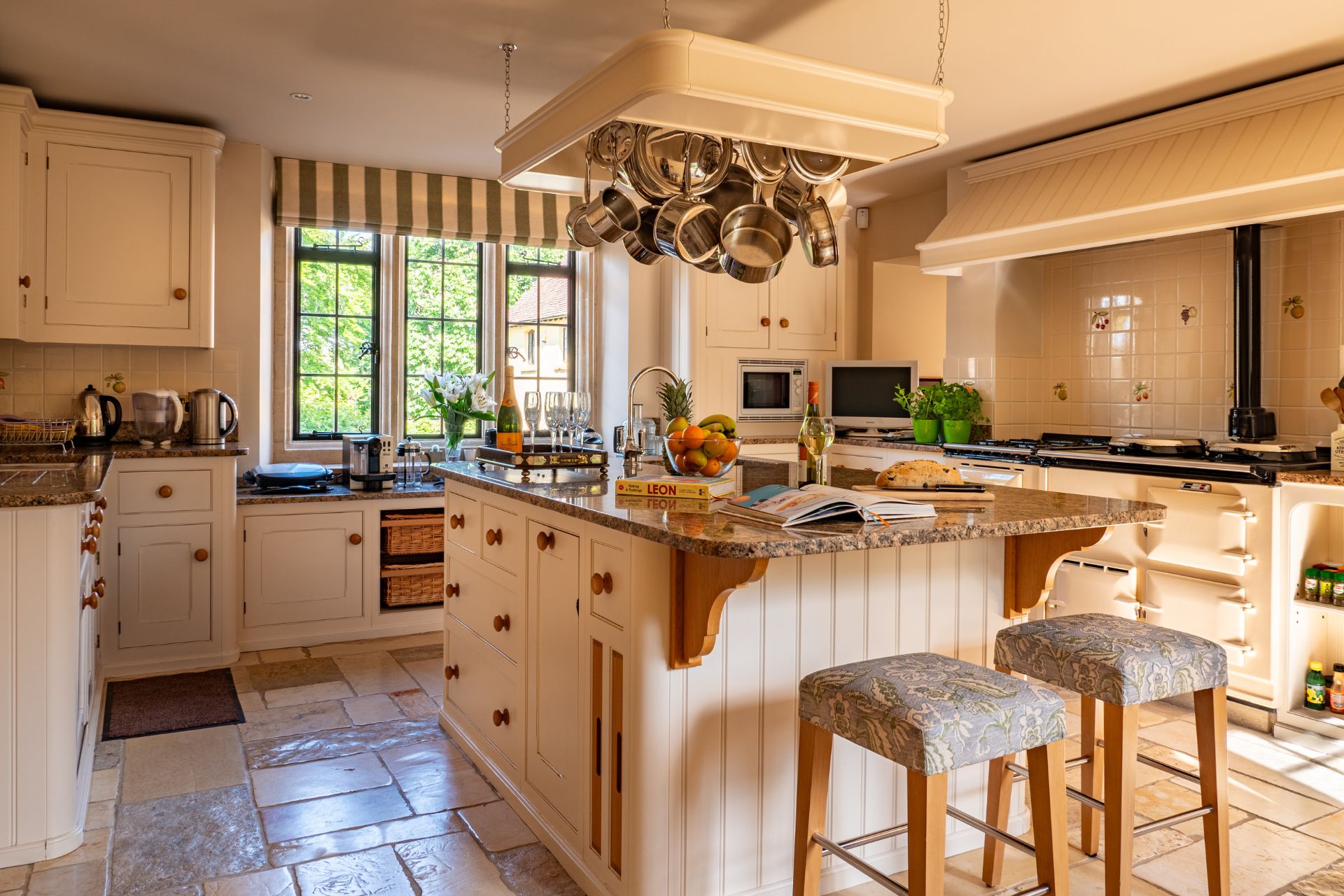 Country kitchen with white cabinets and granite worktops