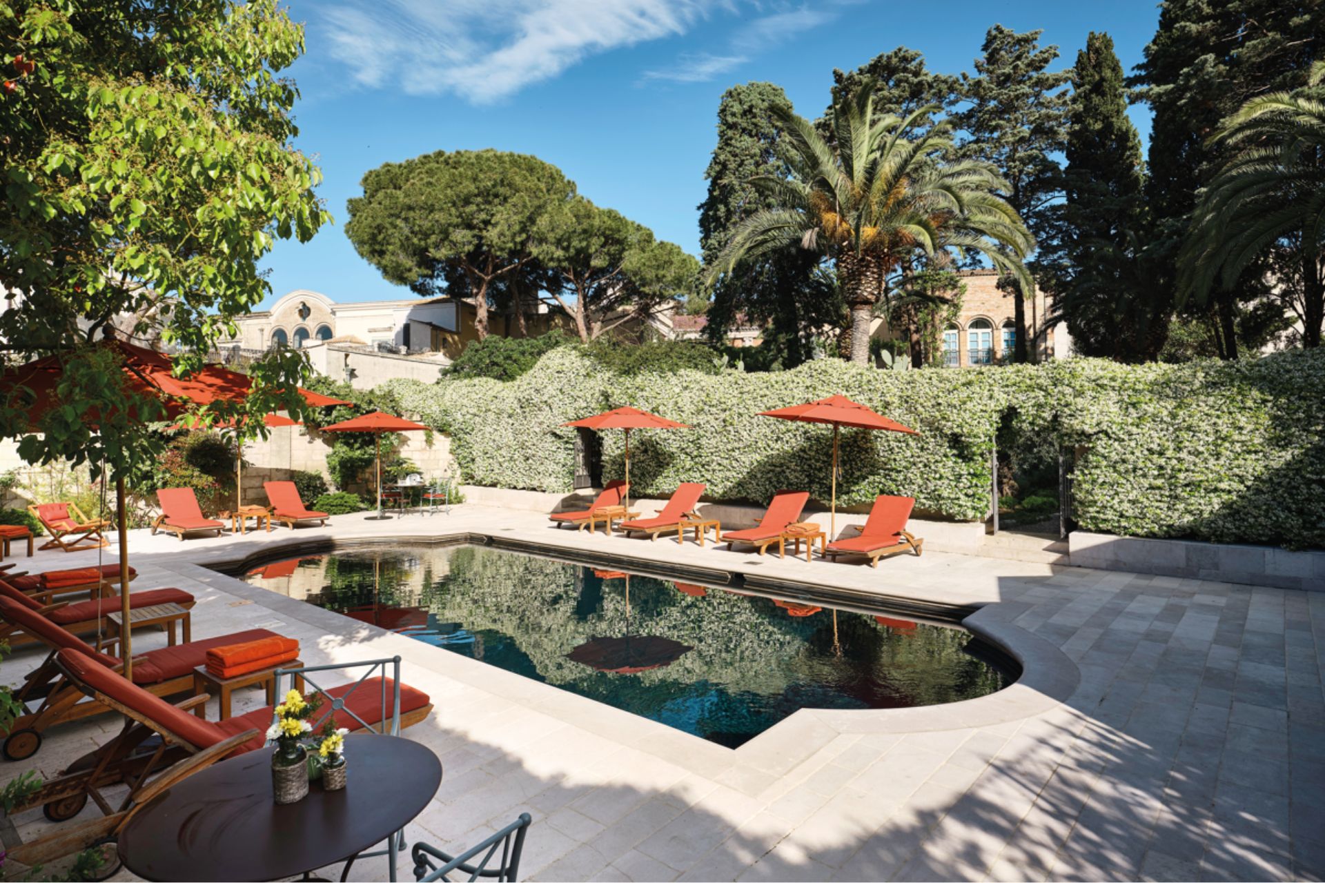 Courtyard pool with orange sun loungers
