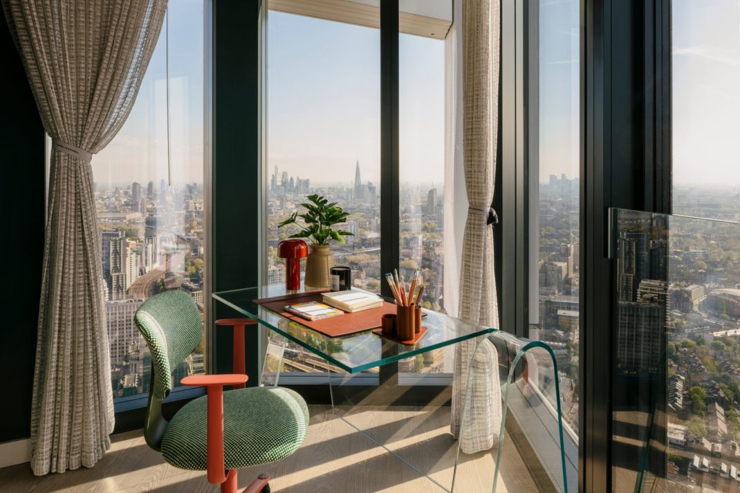 Study with glass desk and floor-to-ceiling windows