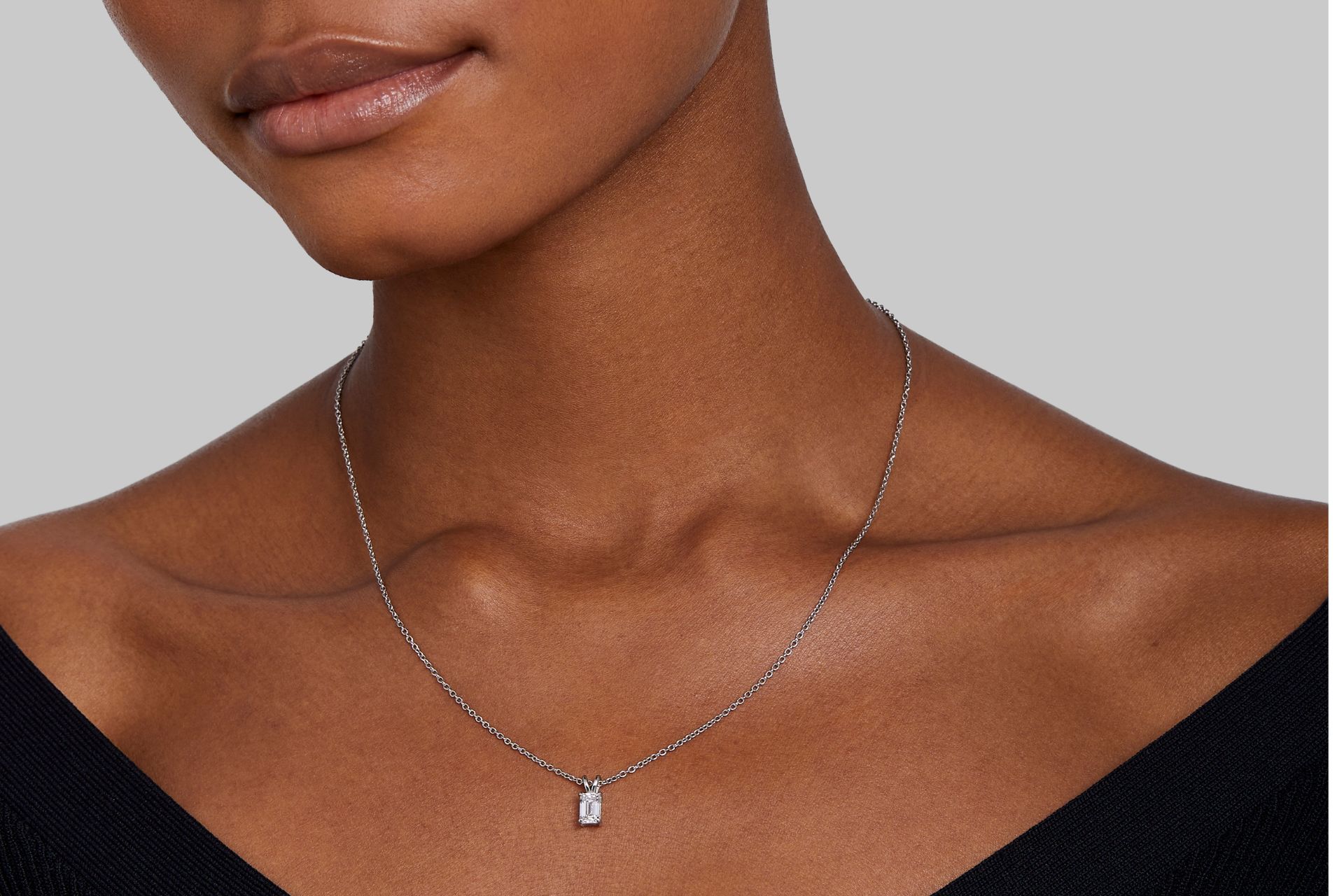 Model wearing square diamond pendant necklace