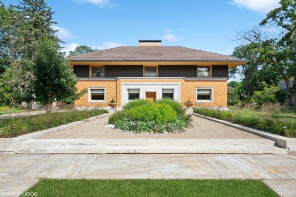 Exterior of Frank Lloyd Wright home with tall windows and large eaves