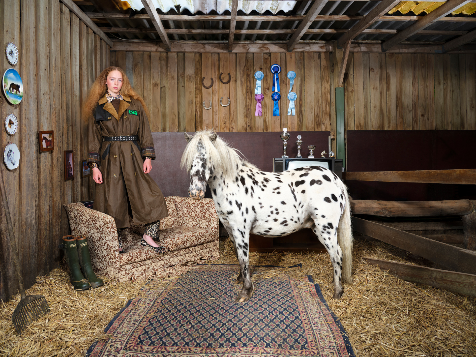 Woman stood in GANN x Barbour coat next to horse