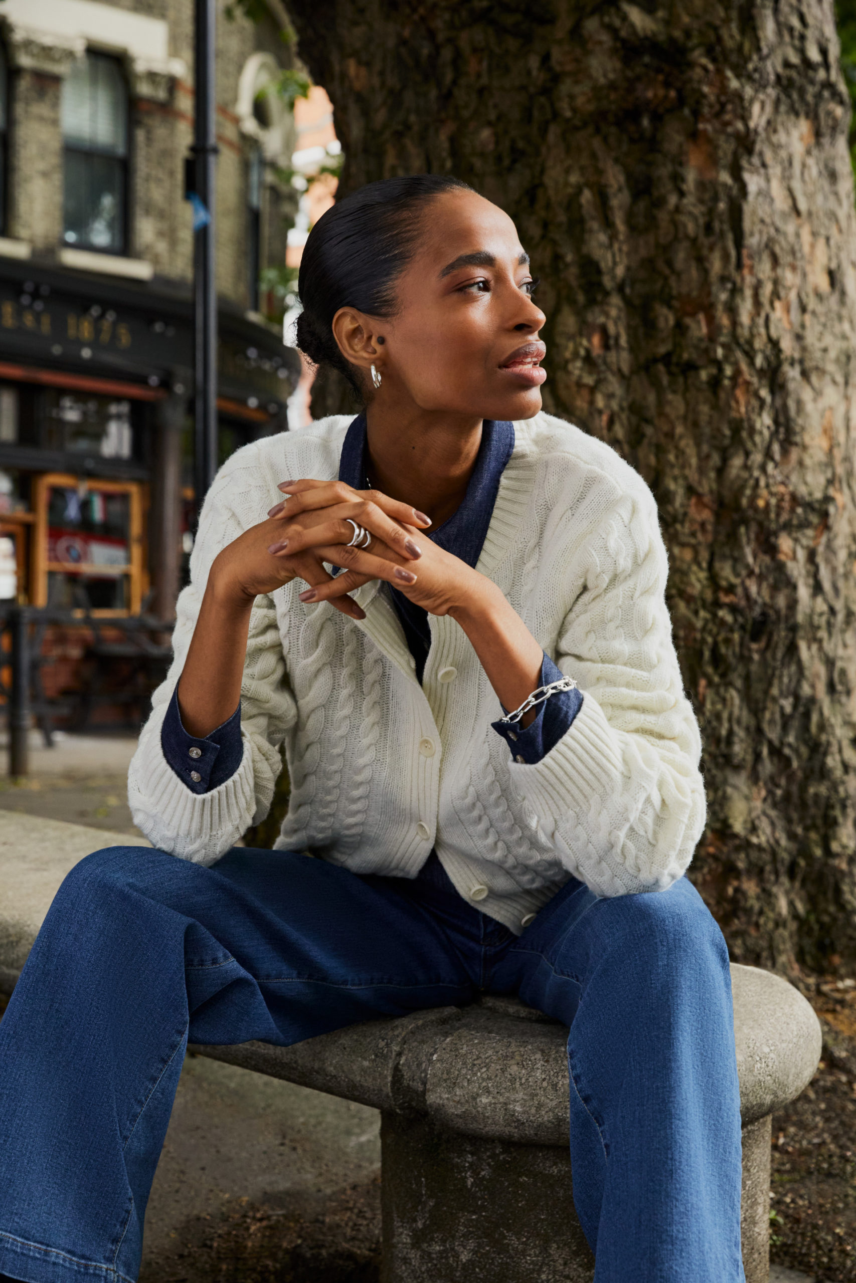 Woman in jumper, shirt and jeans from B Corp brand Baukjen