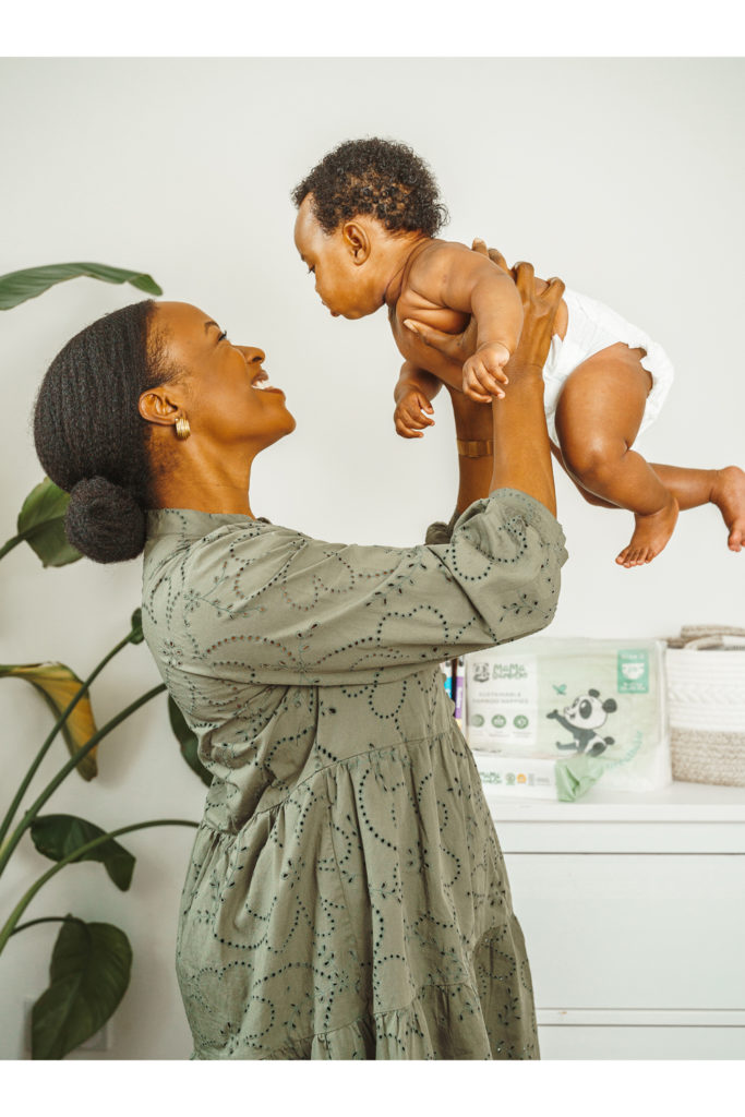A woman holding a baby in a nappy