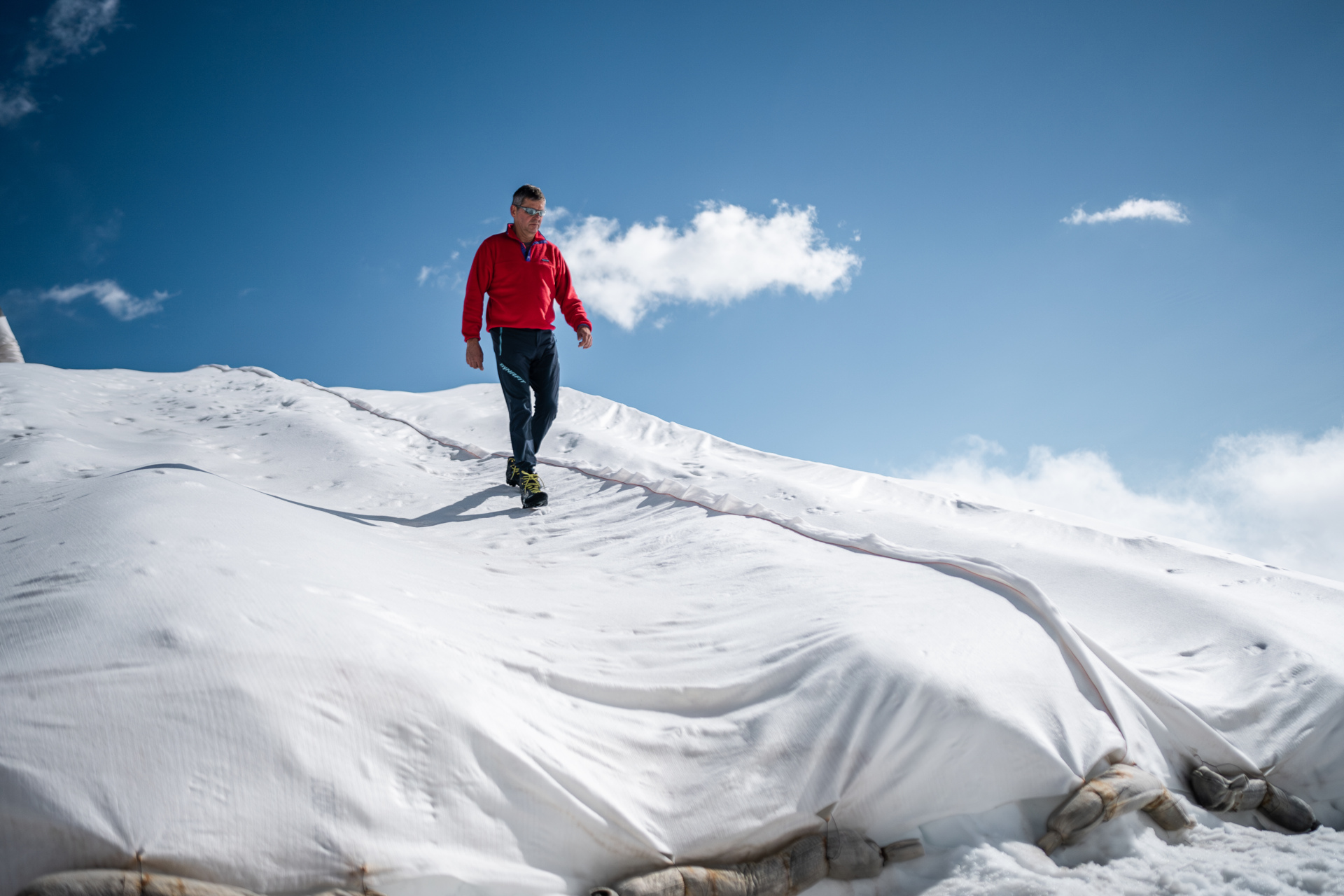 Man walking down snow-capped hill