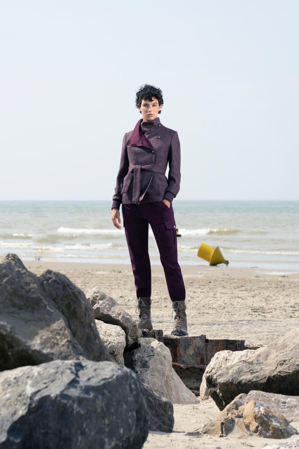 Woman stood on rocks at beach