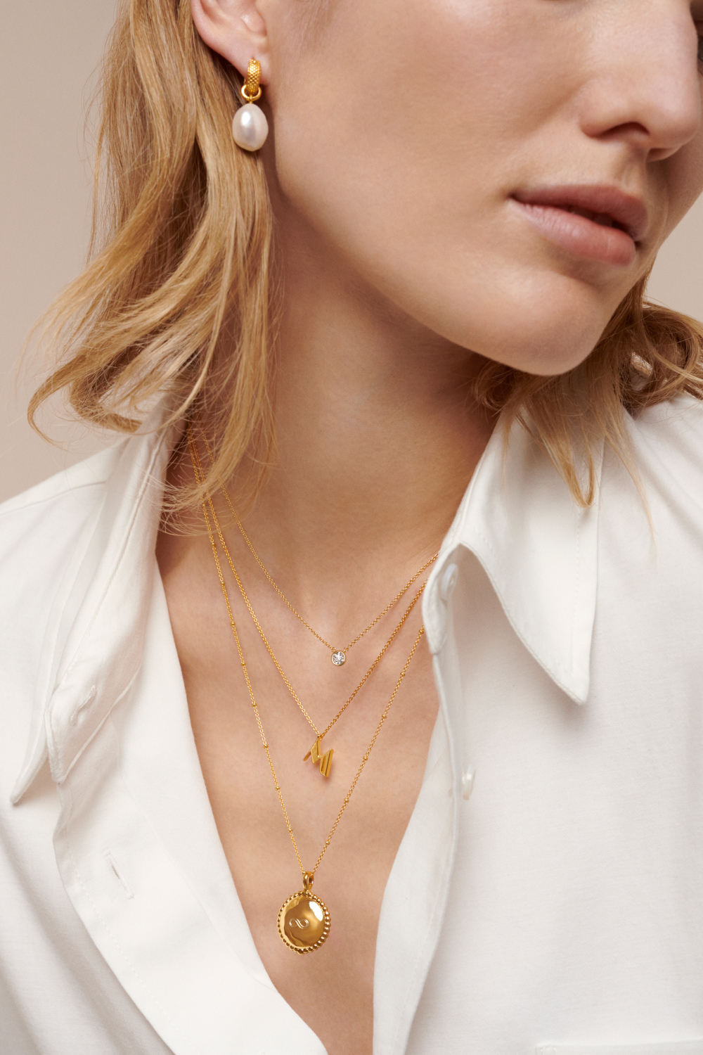 Close up of woman wearing necklaces and earrings