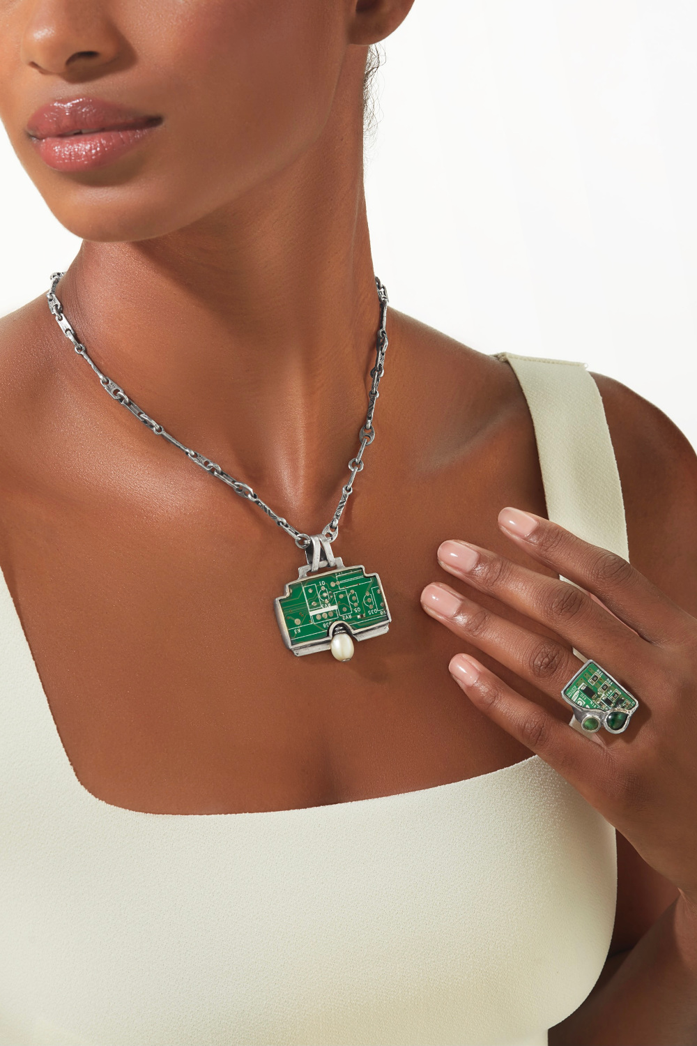 Close up of woman wearing silver necklace and ring