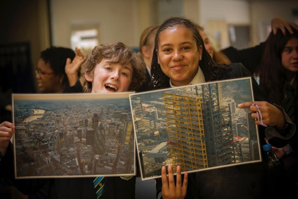 Two kids with pictures of buildings