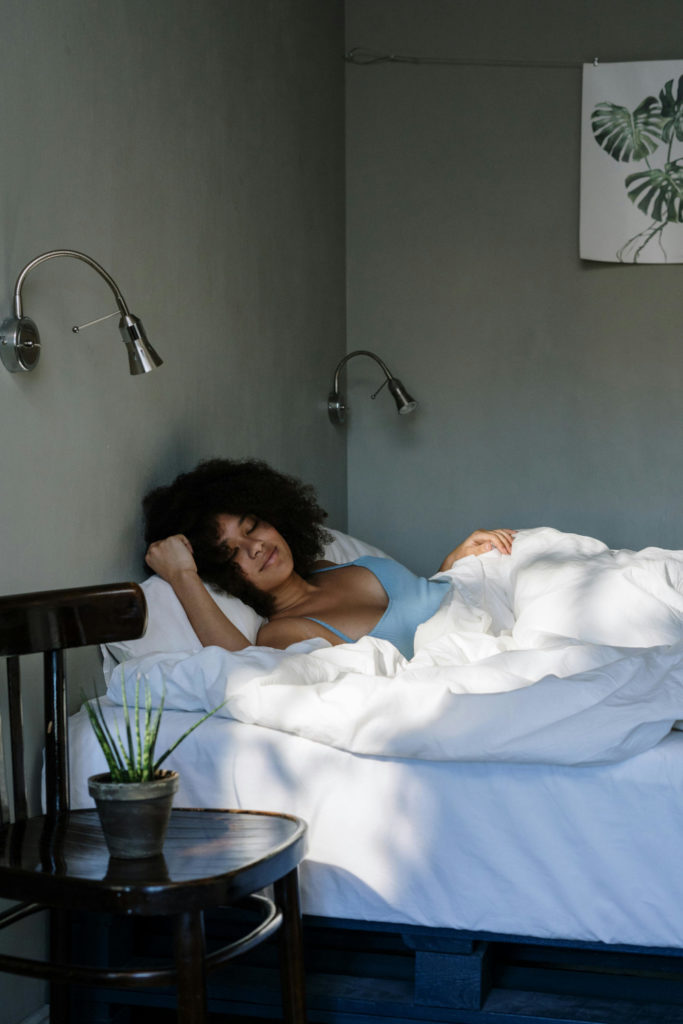 Woman sleeping in bed | clocks go back skin impact