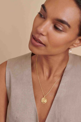Woman wearing Scorpio pendant jewellery