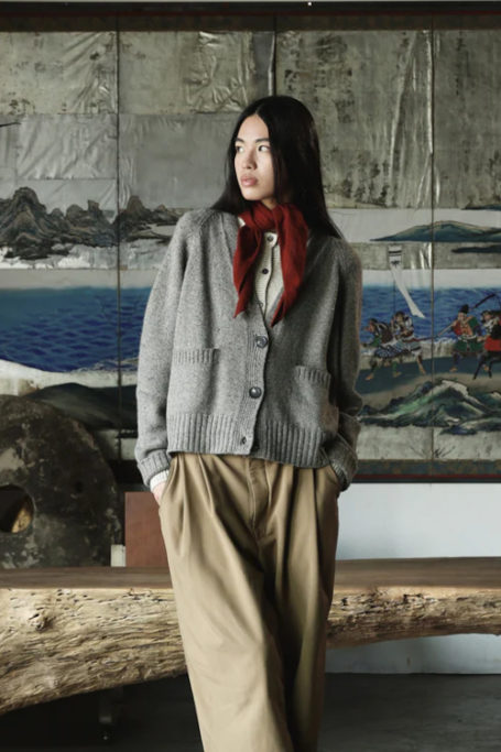 Woman wearing knitted jumper and scarf