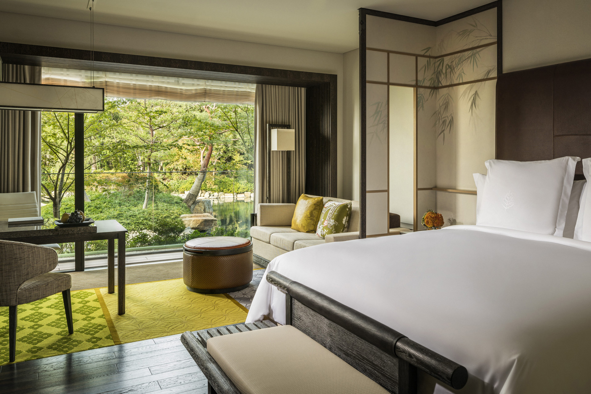 A bedroom with a terrace opening to a garden