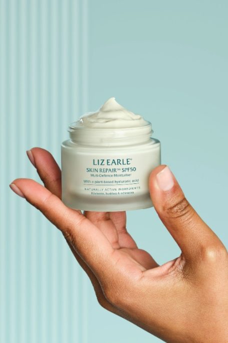 Hand holding Liz Earle cream