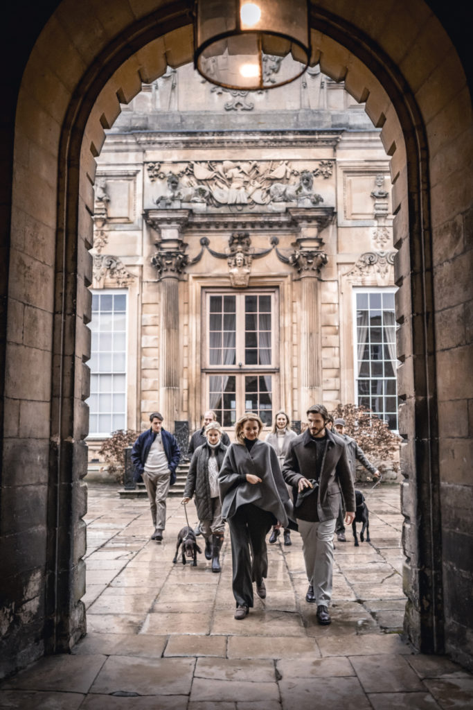 People walking through arch of building wearing Purdey AW24