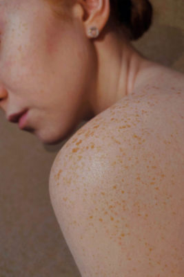 Close up of woman's shoulder and face | skincare trends 2025