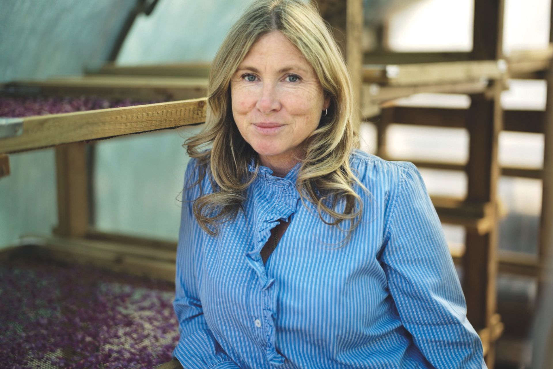 Woman wearing blue striped ruffled shirt