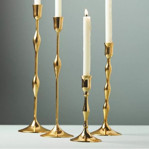 Gold tapered candle holders with white candles