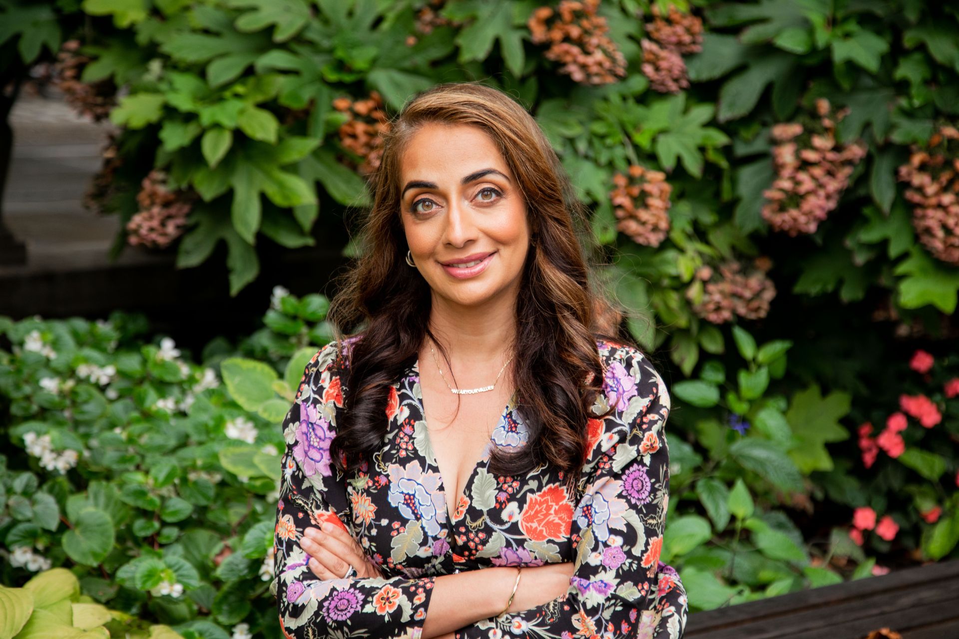 Ayesha Barenblat in front of a leafy backdrop