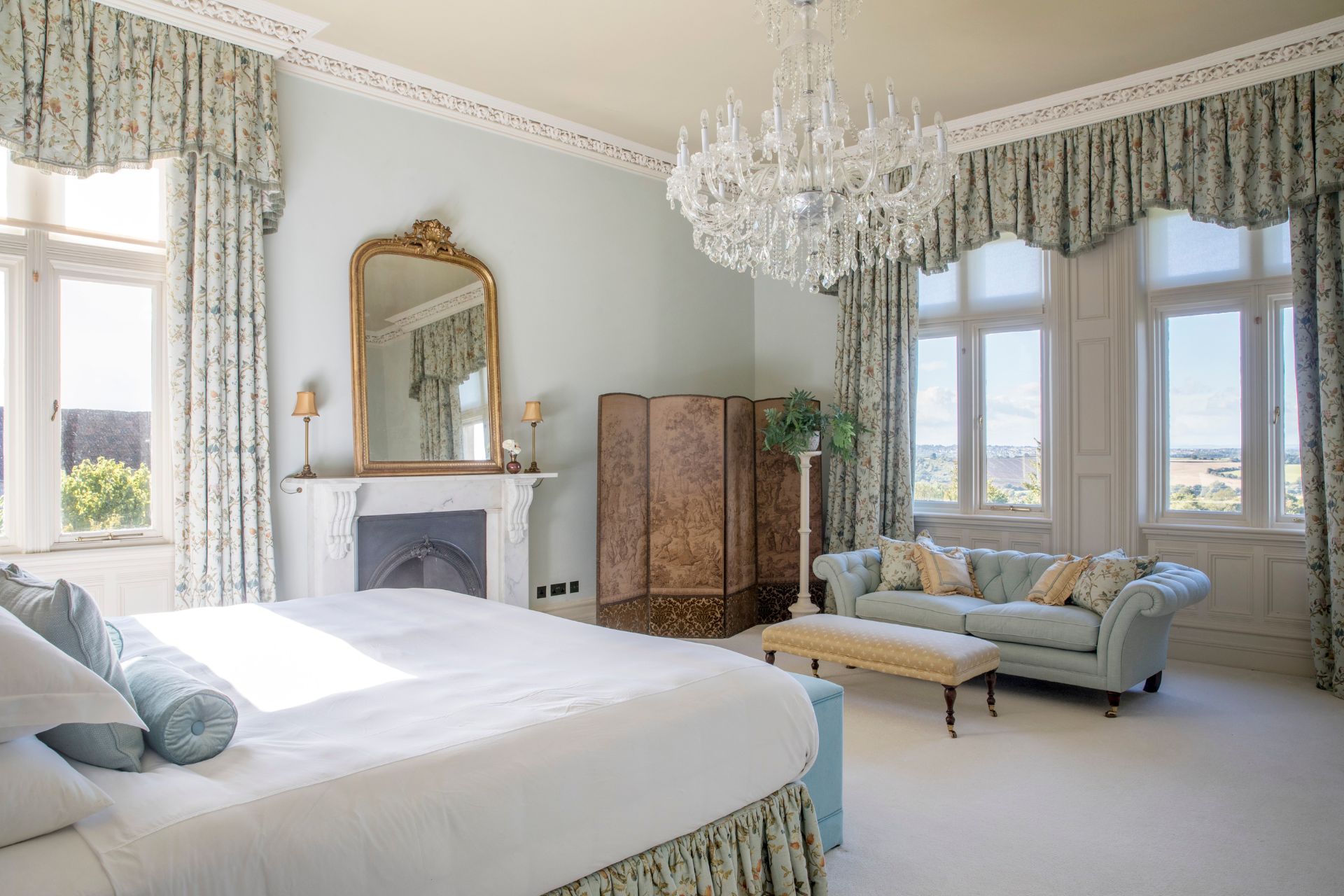 Bedroom wth fireplace and chandelier