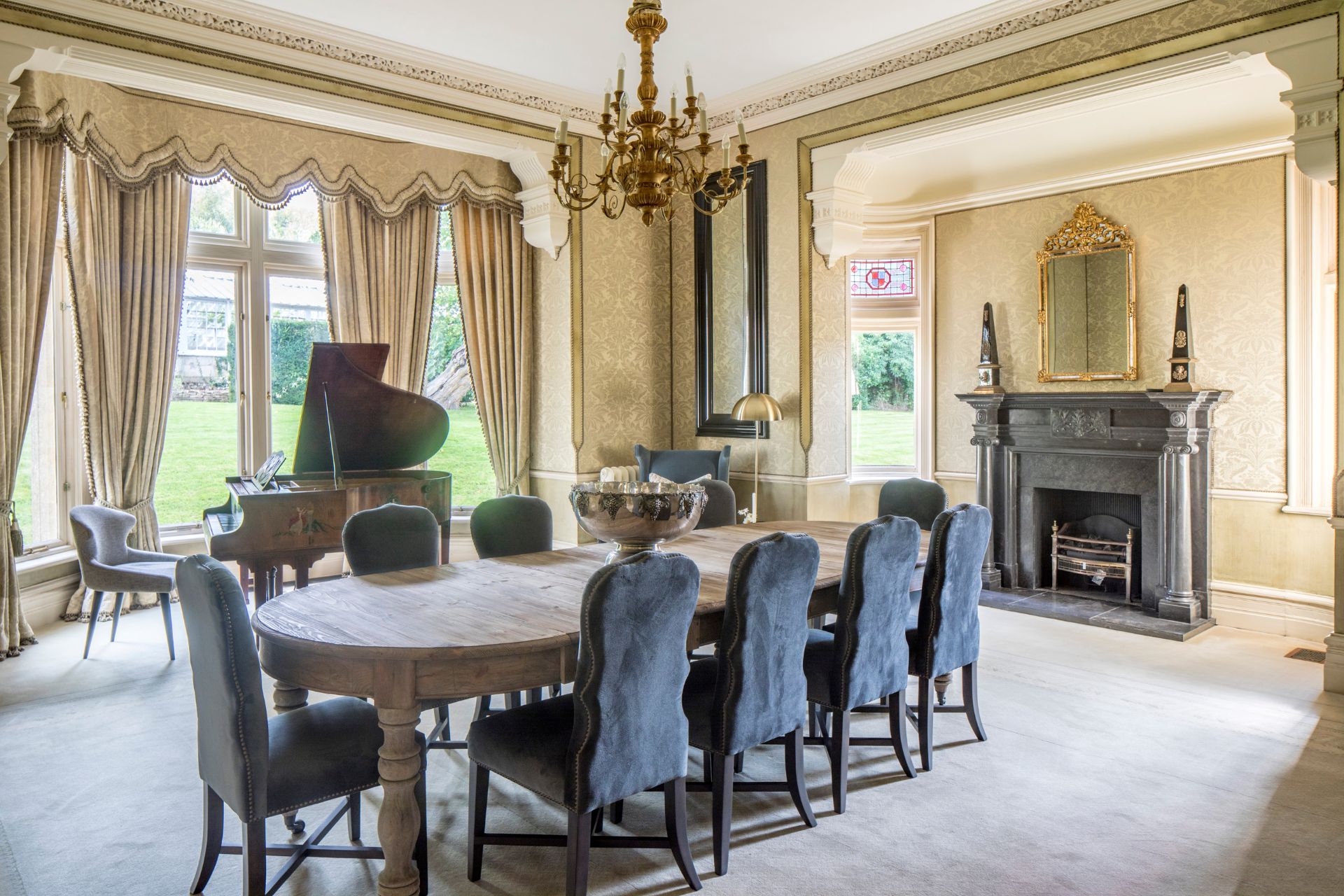 Dining room with navy velvet chairs and a fireplace