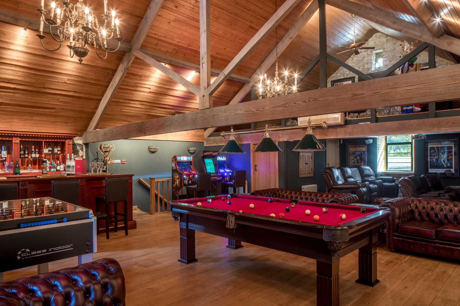Games room with wooden floors and a pool table