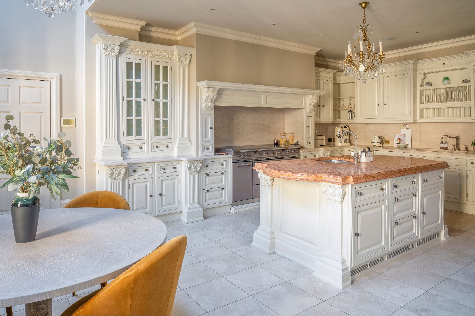 Kitchen with white shaker cabinets and a marble-topped island