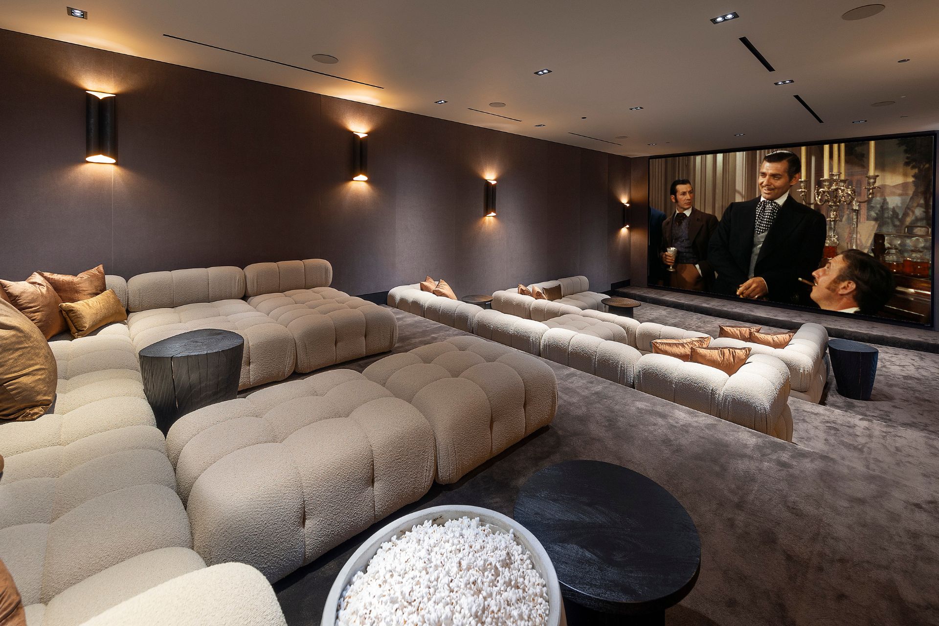 Screening room with cream sofas and grey walls