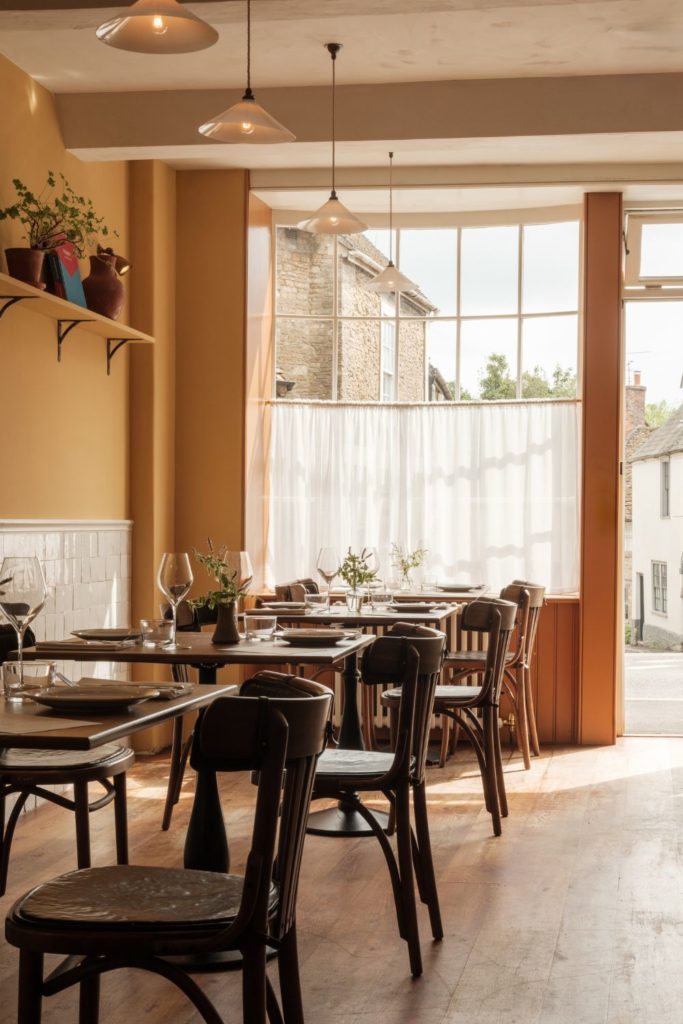 Somerset restaurant with dark wooden furniture and yellow walls