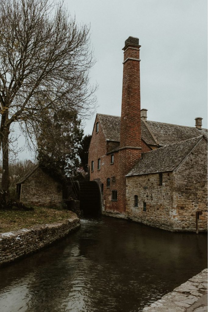 Cotswolds riverside house with tall chimney