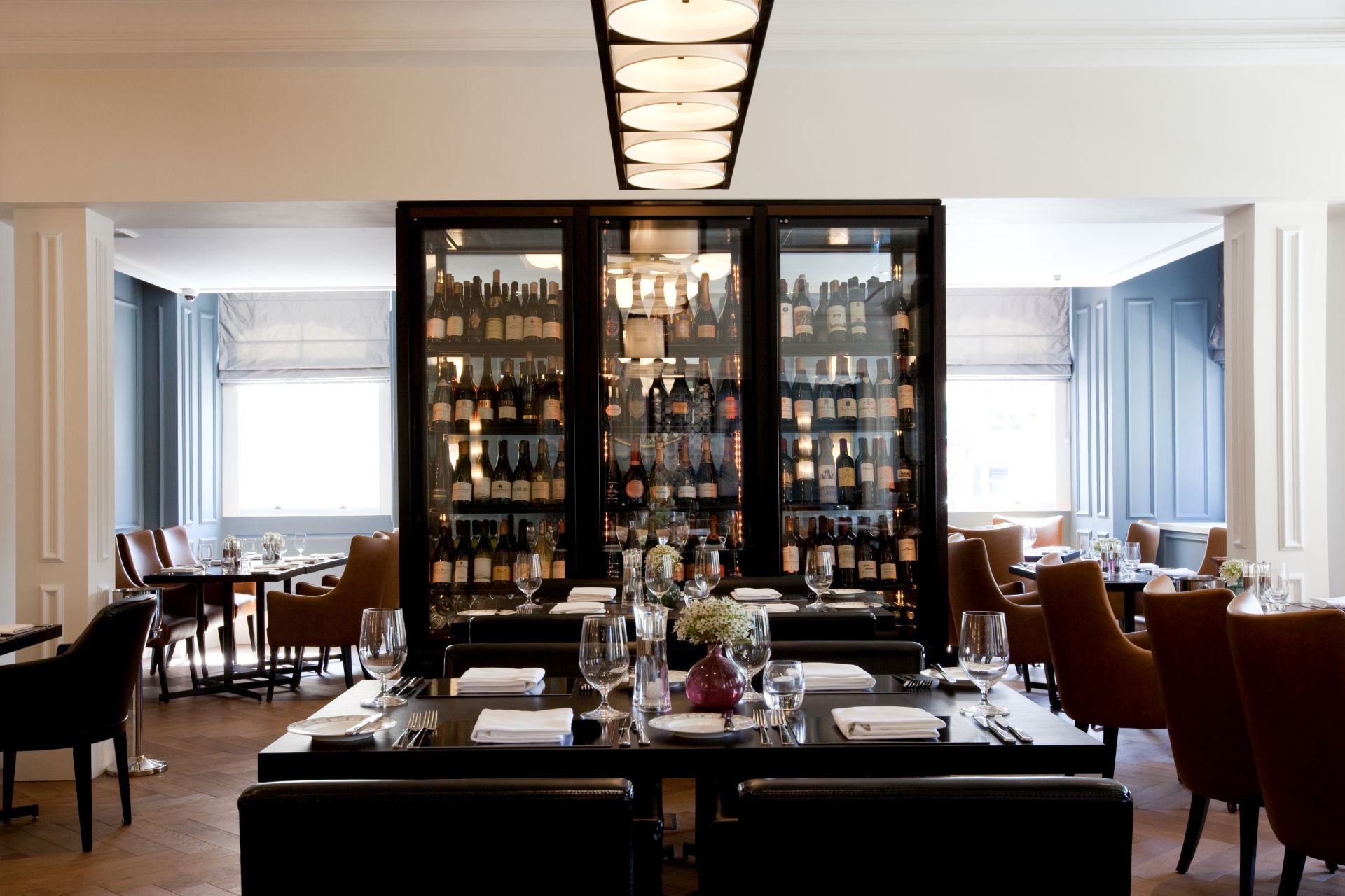 Restaurant with dark wooden furniture and wine cabinet