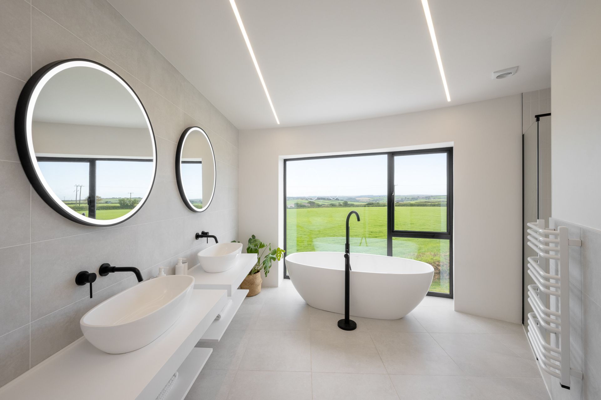 Modern bathroom with double sinks and freestanding bath