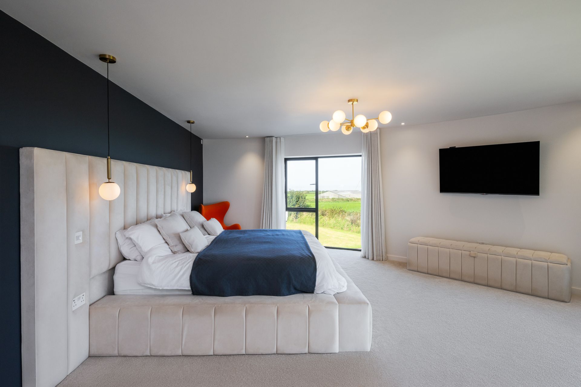 Modern bedroom with cream wraparound headboard