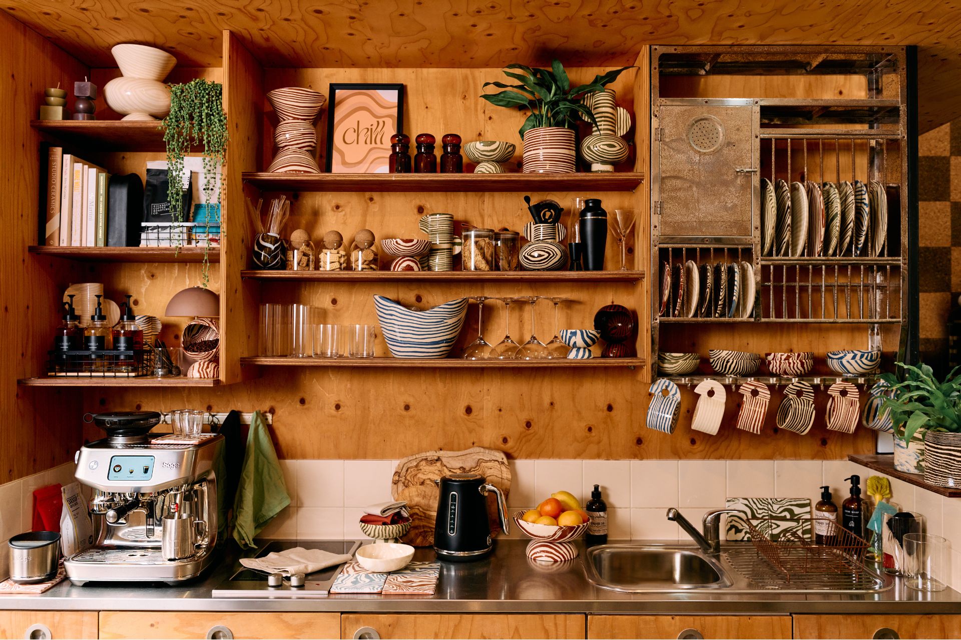 Coffee corner with wooden shelving and a Sage espresso machine