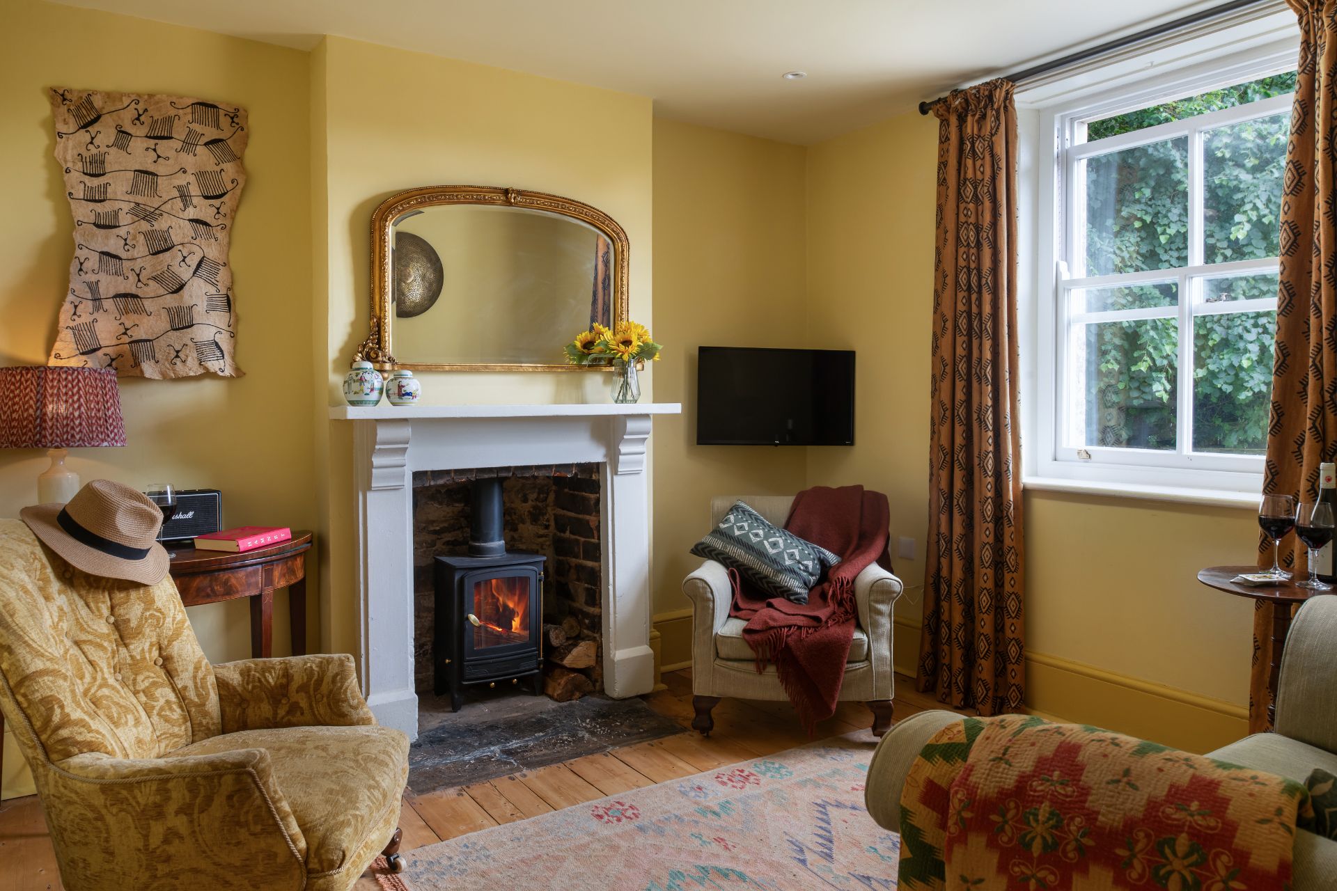 Cottage living room with yellow walls and red curtains