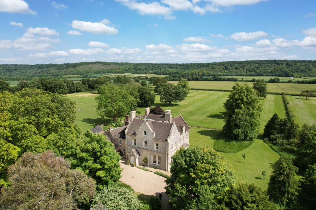 Aerial view of Victorian manor house surrounded by woodland