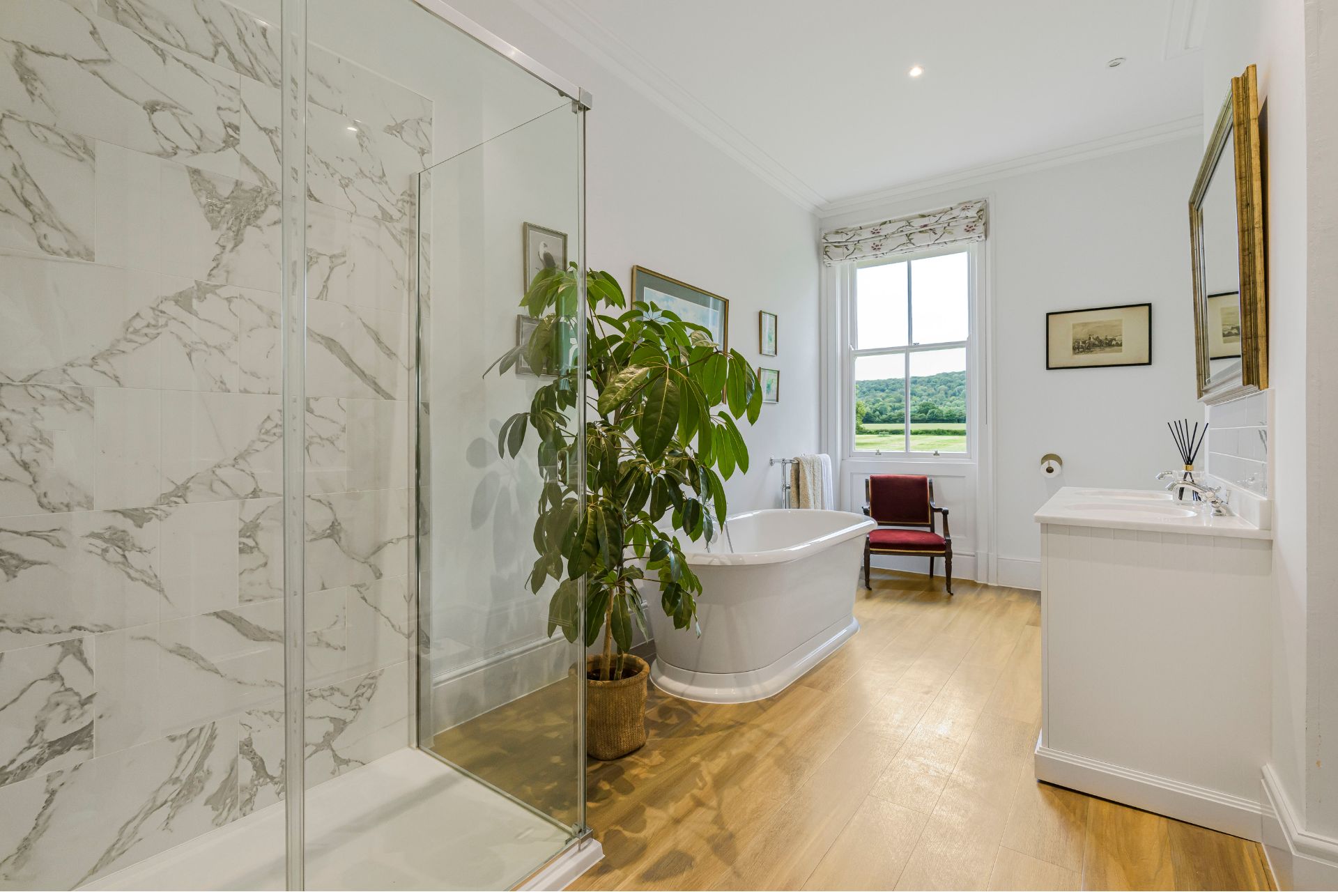 Bathroom with marble tiles and freestanding bathtub