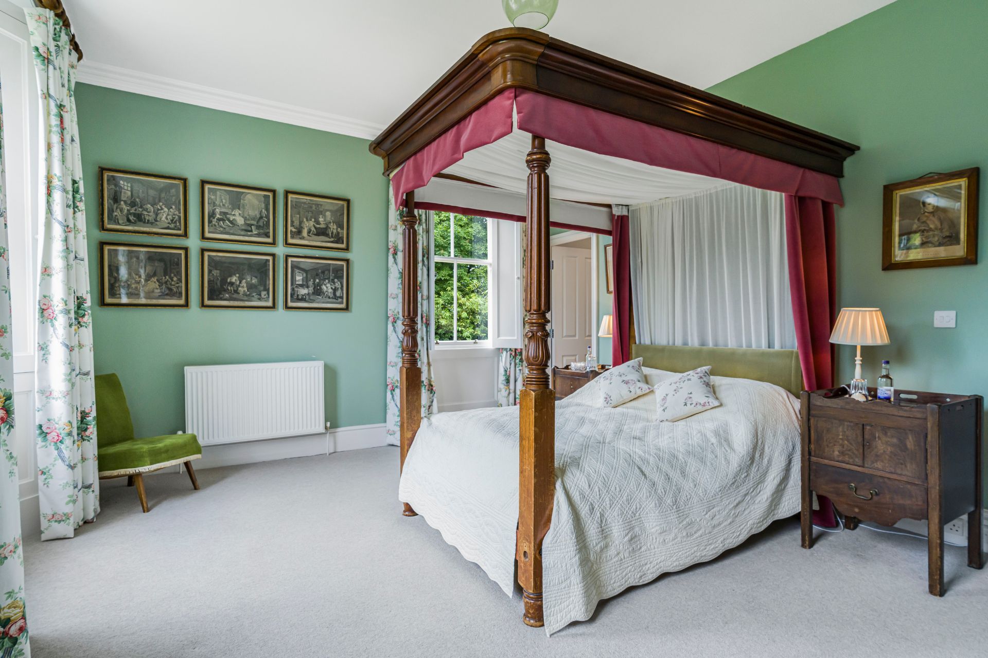 Bedroom with mint green walls and a four poster bed
