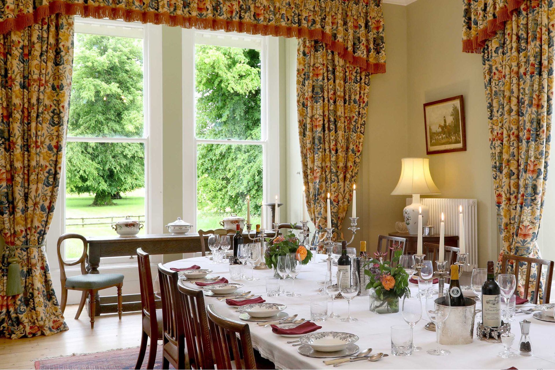 Dining room with white tablecloth and wooden chairs