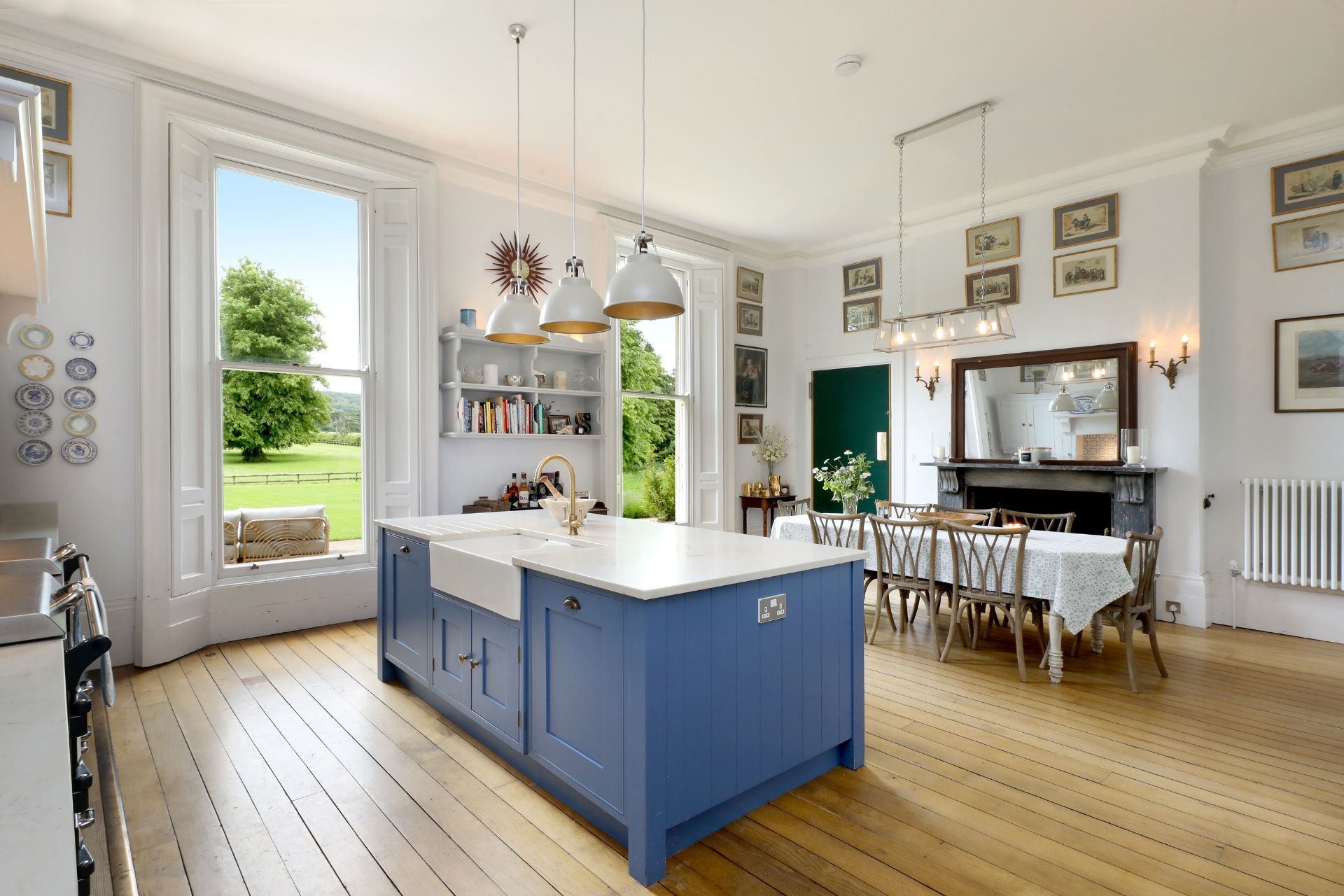 Kitchen with wooden floors and a blue central island