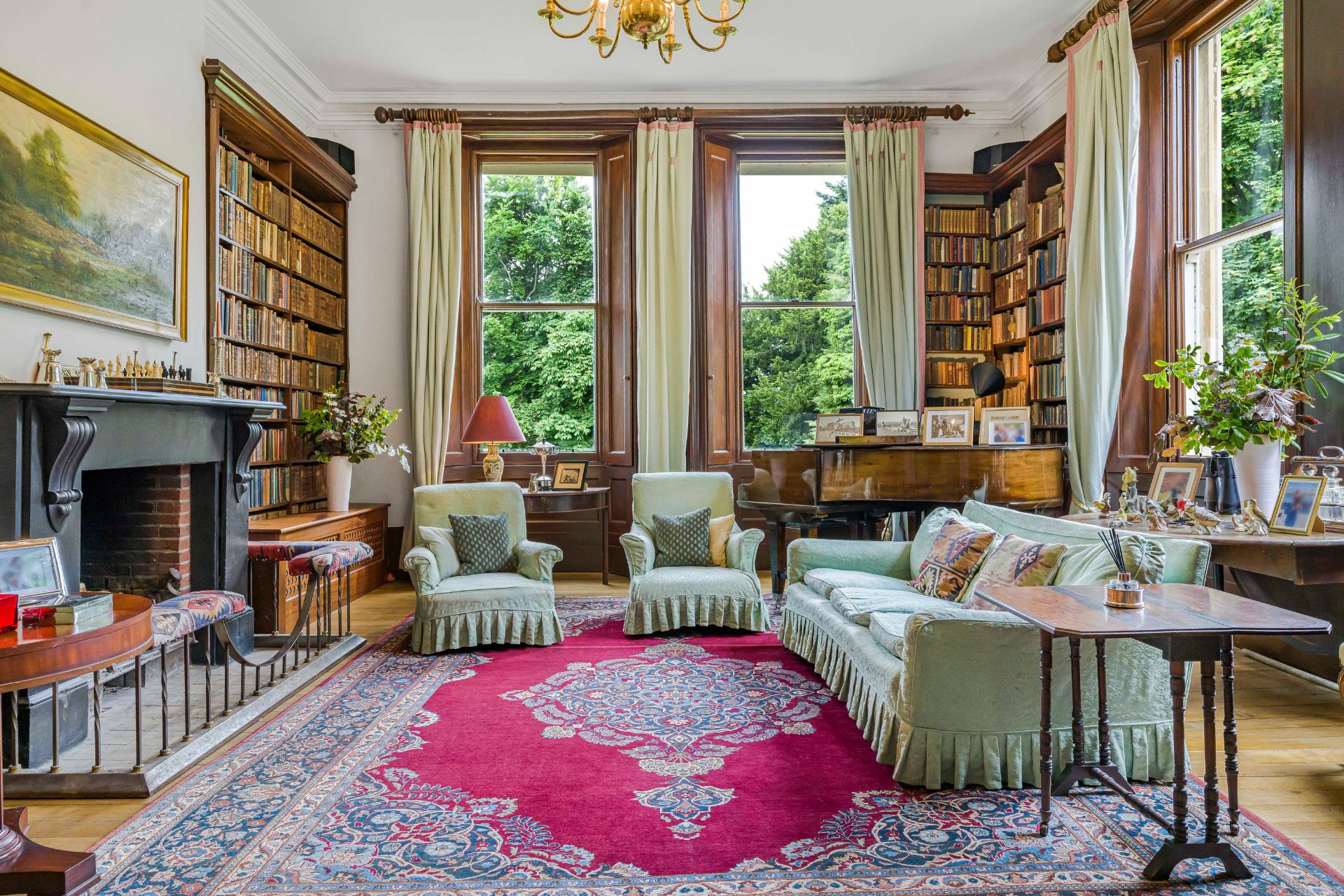 Drawing room with floor-to-ceiling windows and bookshelves